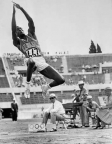 Rafer Johnson long jumping during the decathlon competition at the 1960 Olympics in Rome.